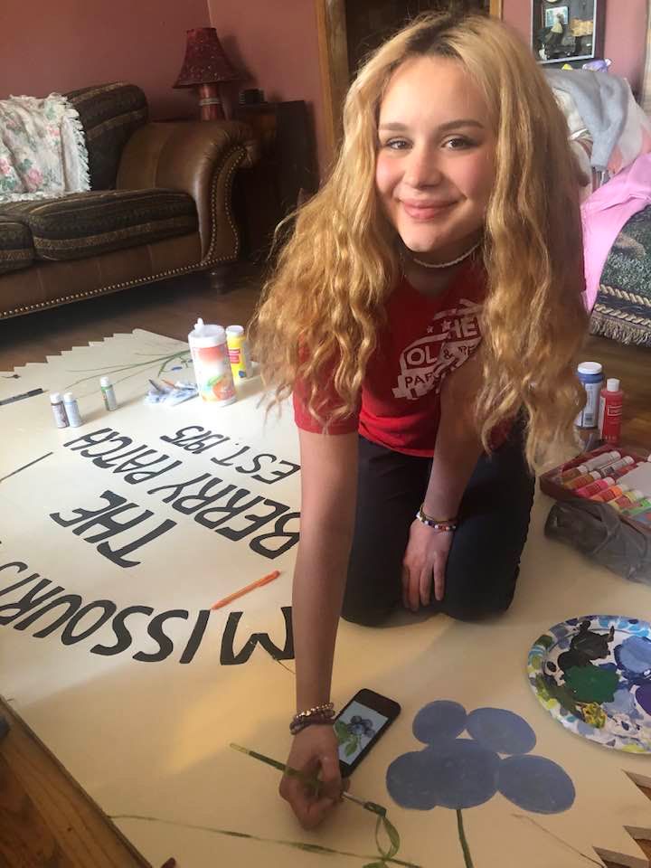 Painting a Sign A student painting a sign during a workshop