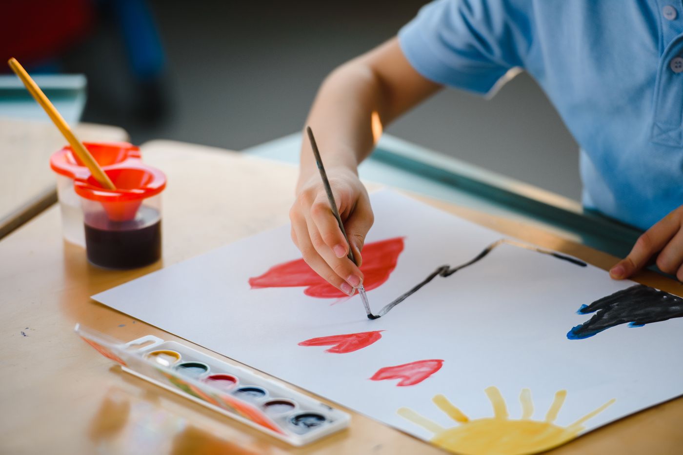 Young child painting with watercolors