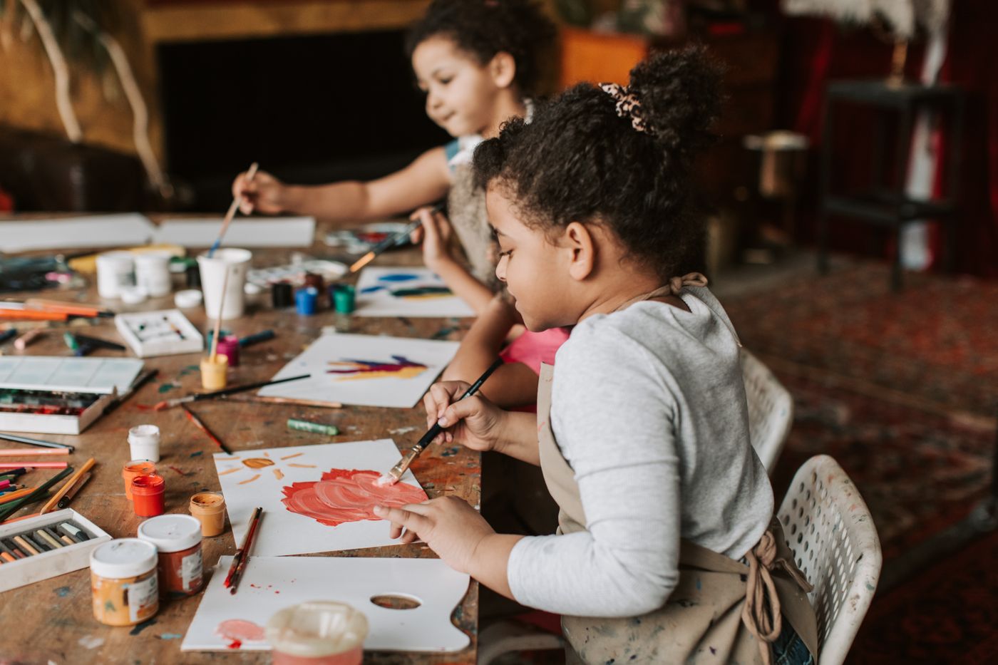 Two children painting together