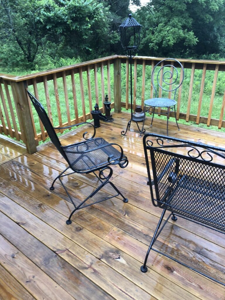 Fresh Rain on the Retreat Deck Ornate iron chairs on a rain-soaked cedar deck at the Missouri retreat.