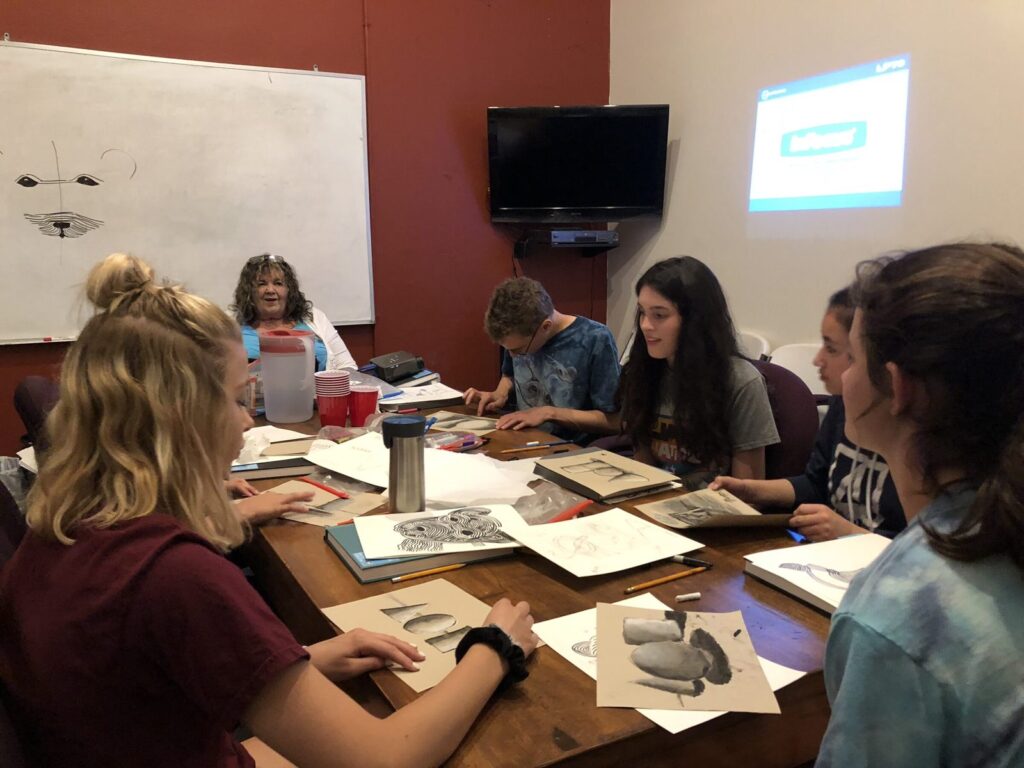 Sharon Jeffus teaching a drawing class to retreat students.