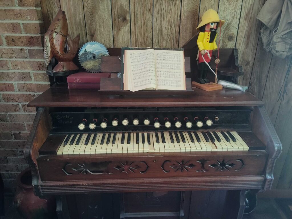 Vintage Organ Music Fisherman Retreat Decor Antique pump organ with sheet music and rustic decor at the fisherman retreat.