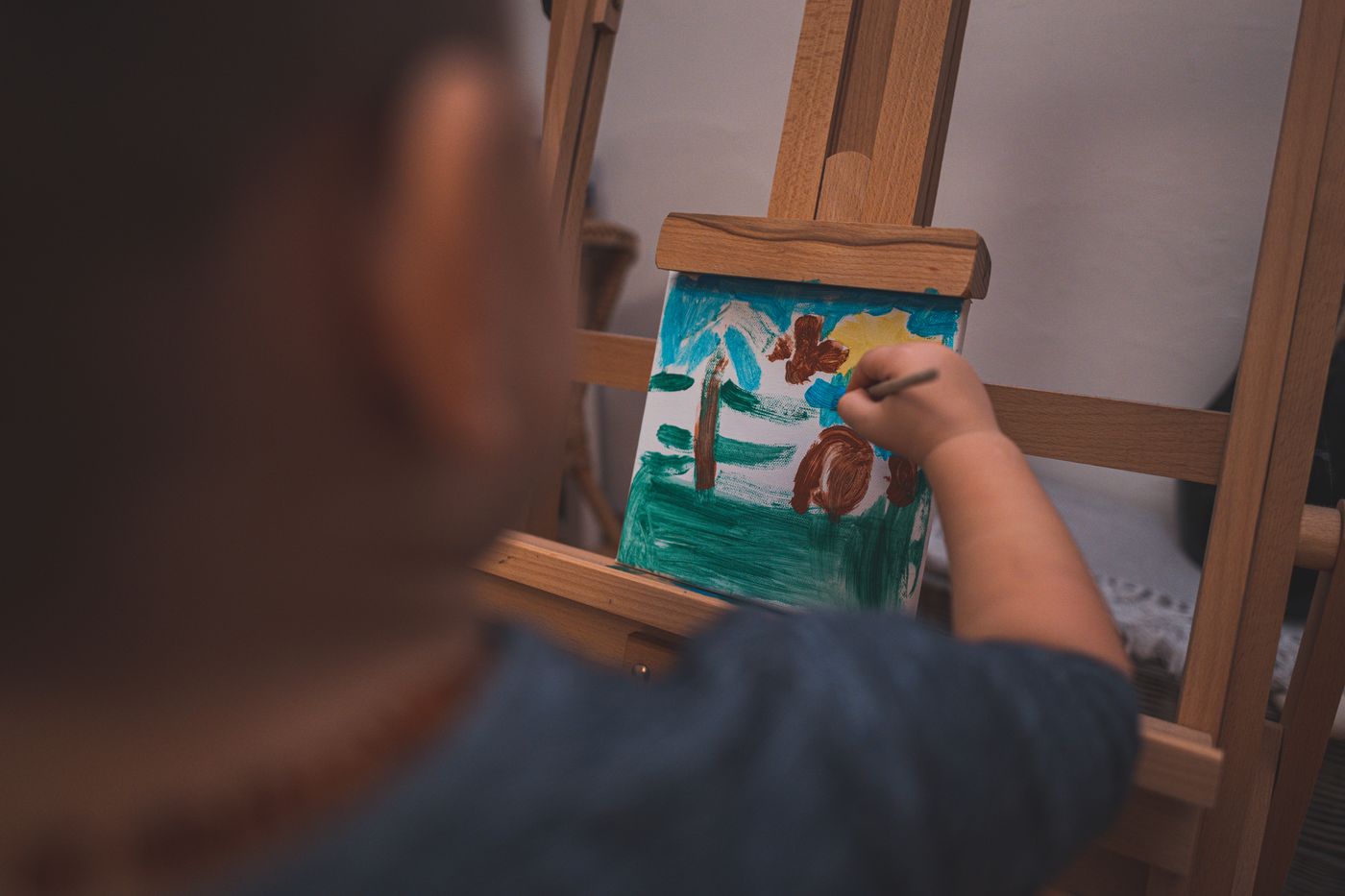 Child painting at an easel